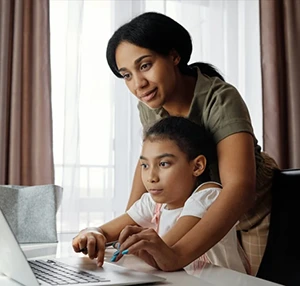 Mother and daughter using laptop