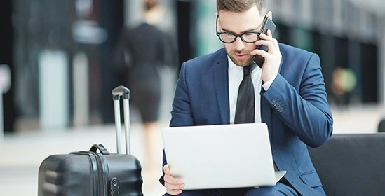 Businessman Traveling with Phone and Laptop